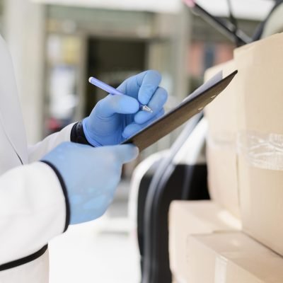 close-up-individual-checking-delivery-list